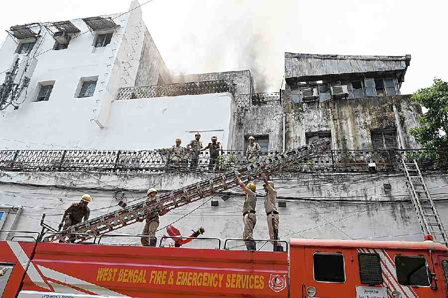 Firemen climb the building in flames