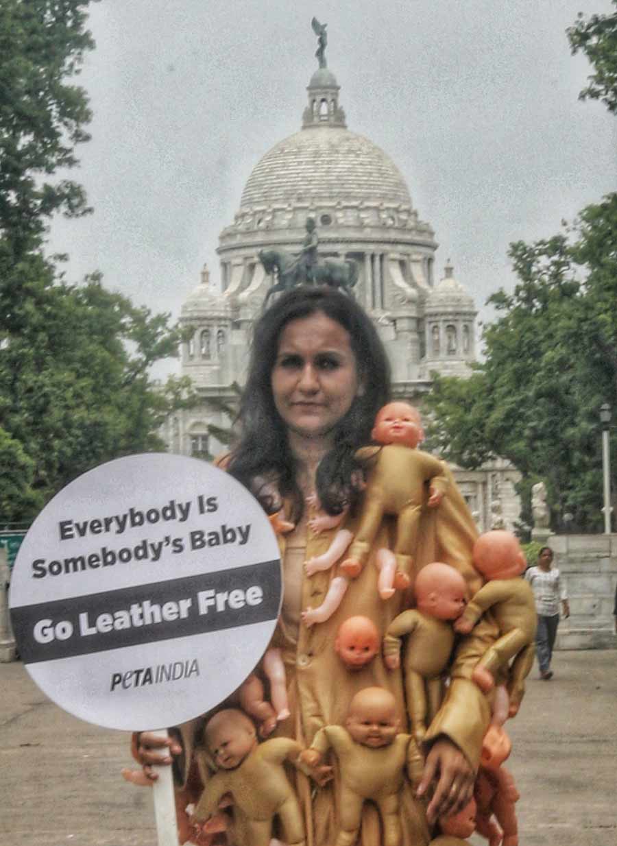 A member of the People for the Ethical Treatment of Animals (PETA), India, wore a coat adorned with the arms, legs and heads of baby dolls and displayed a signboard which read ‘Everybody is somebody's baby: Go leather-free in Kolkata’ on Friday afternoon in front of Victoria Memorial
