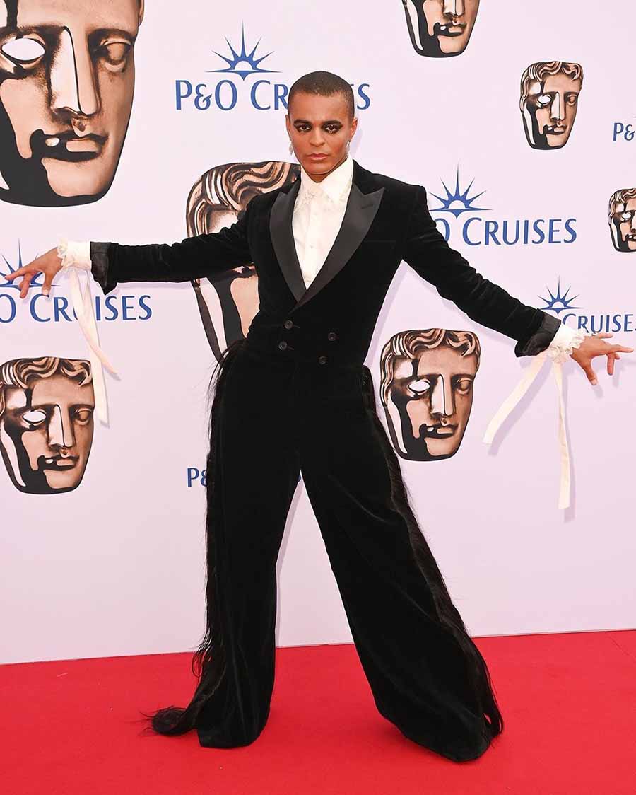 Bad Education actor Layton Williams opted for a black suit with flared pants. 