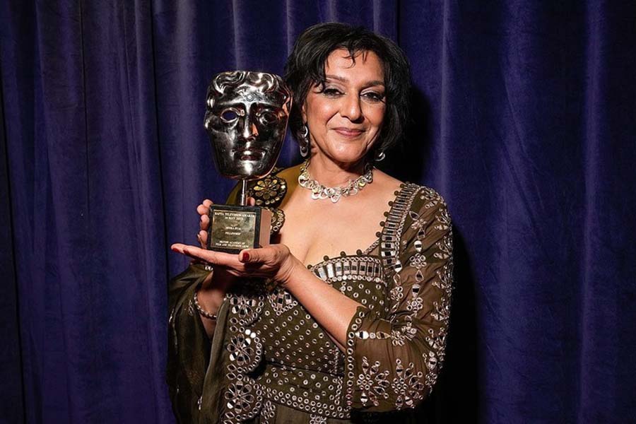 Meera Syal posed with her Fellowship Award, sporting a brown dress studded with glass gems.