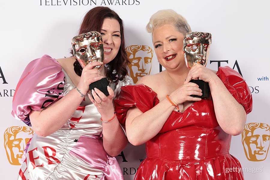 Lisa McGee donned a white-and-pink gown, while Siobhán McSweeney wore a red gown. The duo posed with their Scripted Comedy Award for Derry Girls