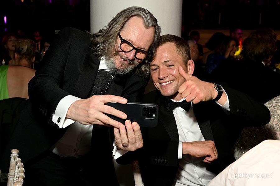 Gary Oldman and Taron Egerton posed for a selfie, twinning in black suits.