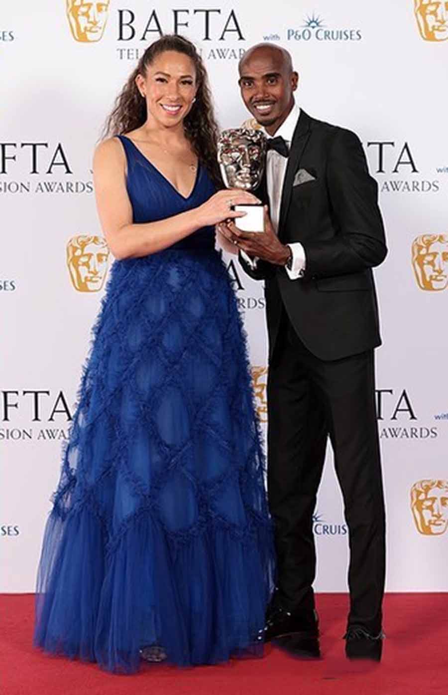 Tania Farah looked regal in a blue gown as she posed with Sir Mo Farah, who wore a black suit. The two won an award for Single Documentary The Real Mo Farah.
