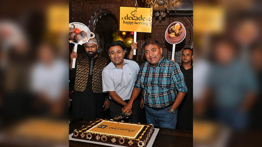 Debaditya (left) and Shiladitya Chaudhury cut a cake to celebrate the landmark year