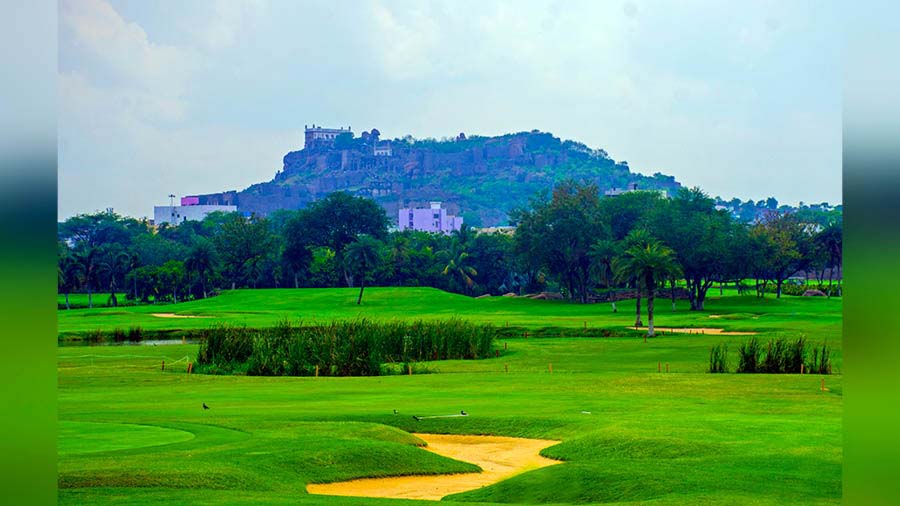 The Golkonda Fort towers above the golfing green, complete with sand bunker, of Naya Qila 