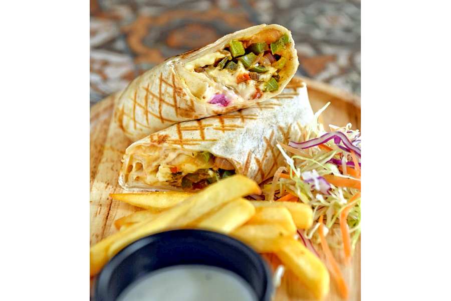 Paneer Tikka Wrap is a fusion dish that’s sure to take care of your hunger pangs. An interesting and innovative street-style wrap made with the goodness of paneer cubes marinated with lip-smacking tikka spices. Paired with some crispy French fries. Rs 180