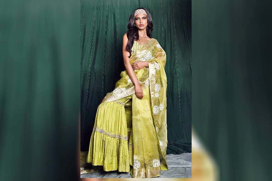 If you are not game for a classic drape and want to keep the style quotient high for a mehndi or sangeet function, Ankita’s lime green organza with an embroidered border, paired with a beaded blouse and a pair of sharara pants, is a classy style to sport.