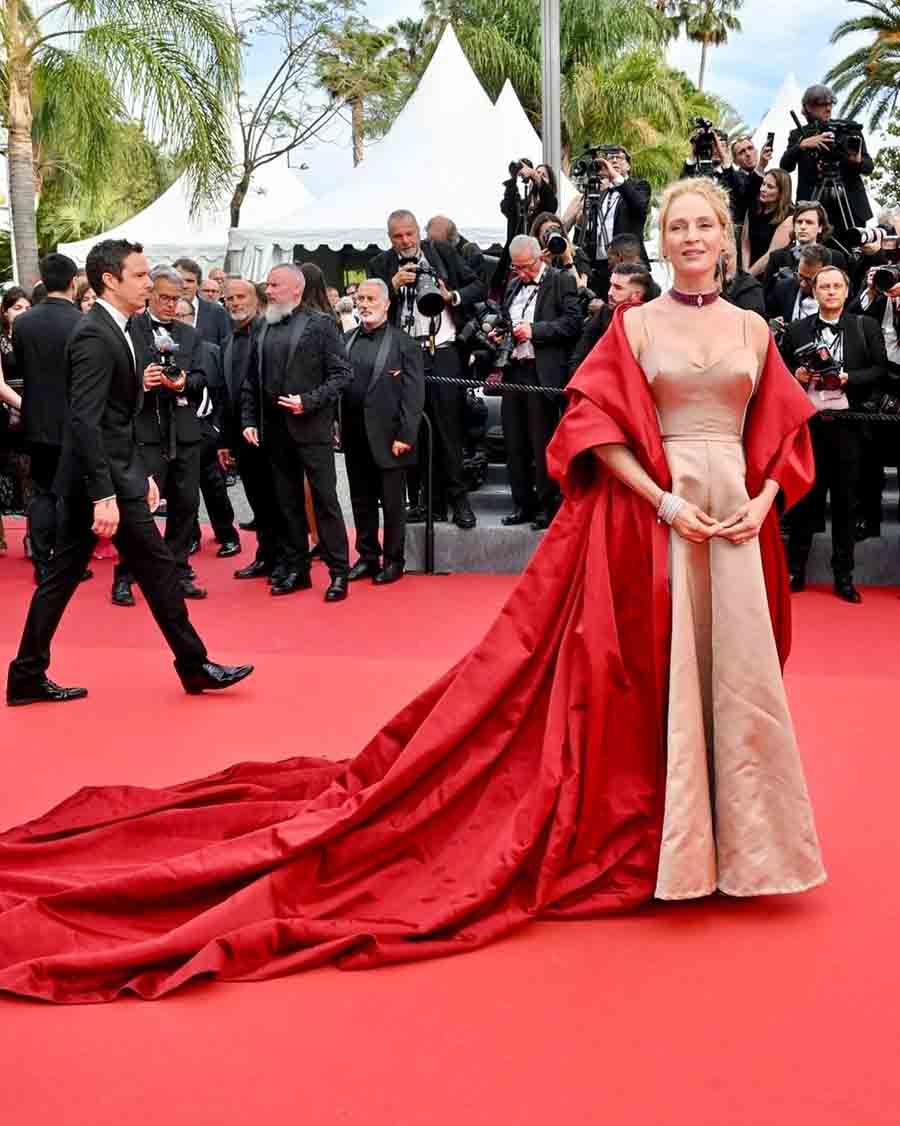 Uma Thurman opted for a champagne-coloured gown paired with a striking red cape by Dior.
