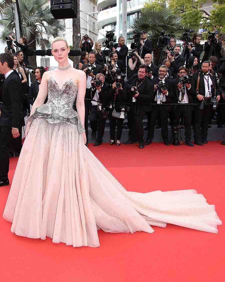Elle Fanning arrived at the red carpet in an Alexander McQueen gown complemented by a silver embellished top and a flowy cream skirt. 