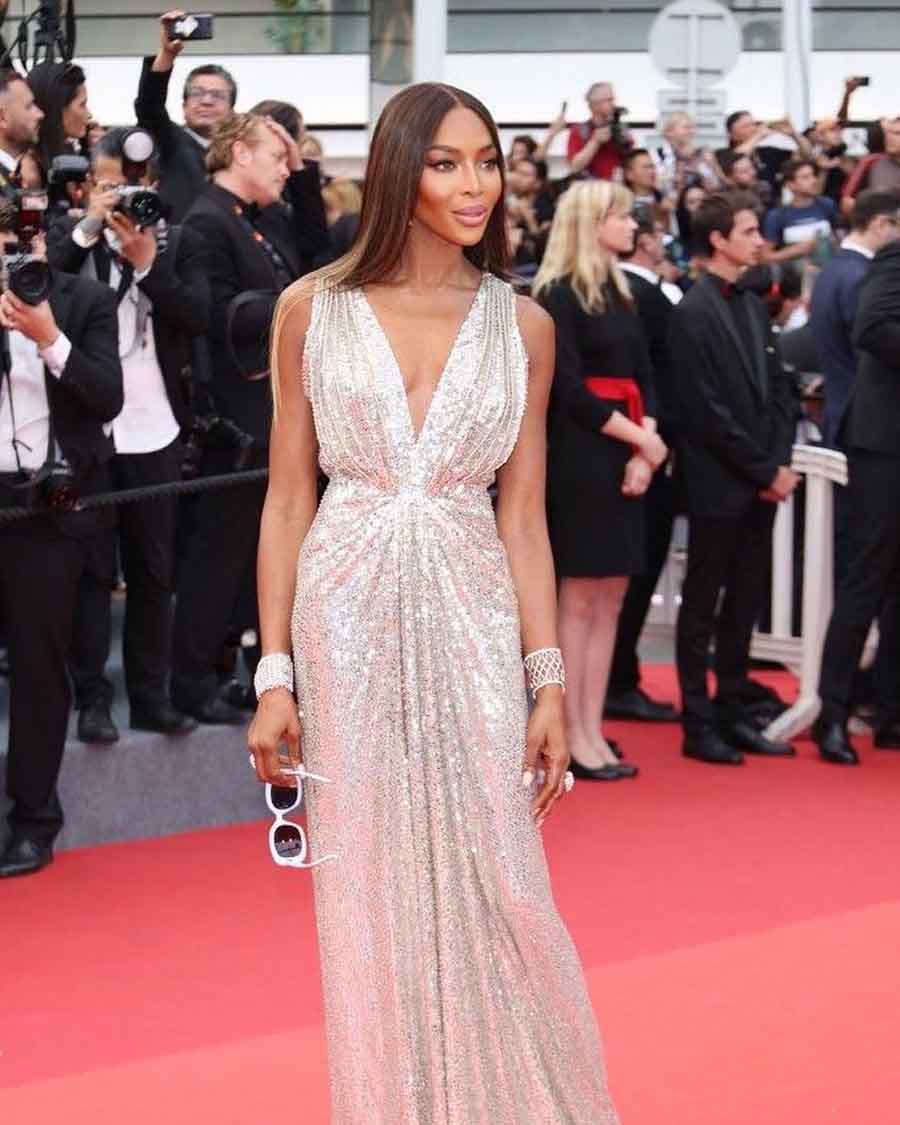 Naomi Campbell wore a silver sequinned Celine gown with a plunging neckline and paired it with Chopard jewellery and matching heels by Alexandre Birman.