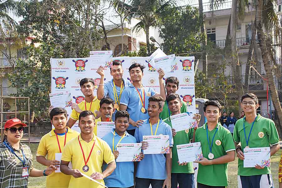 Winners pose with medals and certificates at a ground in FE Block 