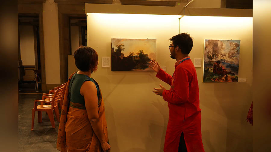 A student discusses the nuances of a painting with Paula Sengupta