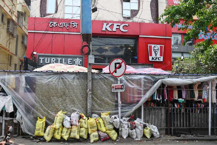 Plastic sheets over hawkers’ stalls in Gariahat on Sunday.