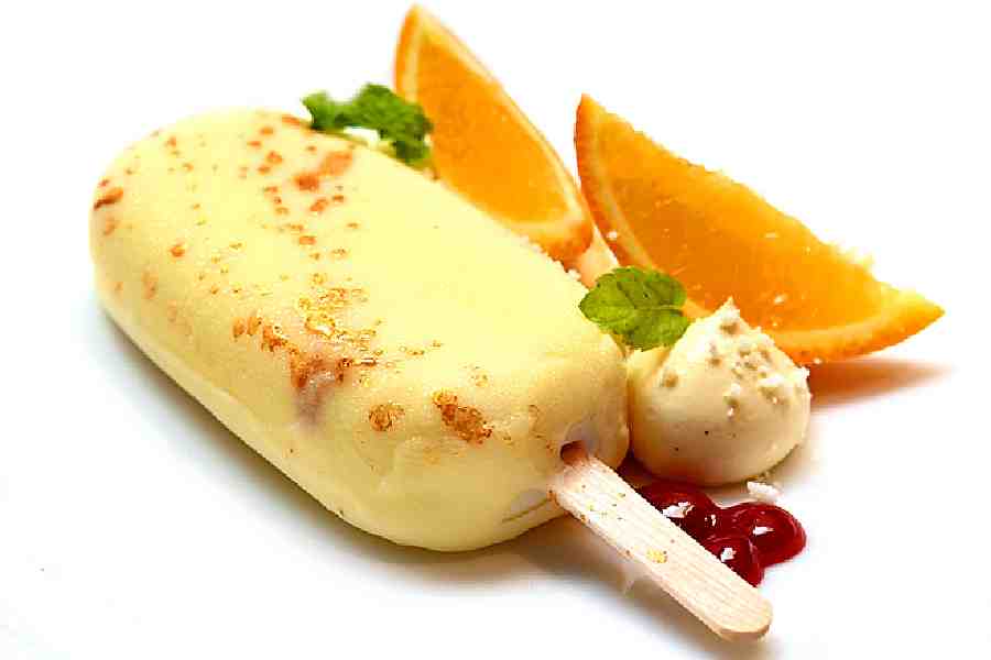 Baked Yoghurt Popsicle: Baked Mishti Doi encased within a white chocolate and cocoa butter popsicle. It is served along with some passion fruit cremeux, and berry gel on a bed of caramelised white chocolate soil.