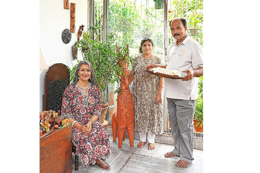 Nandita Palchoudhuri with terracotta artist Dolon Kundu and shola artist Sunil Halder, at her residence in Ballygunge
