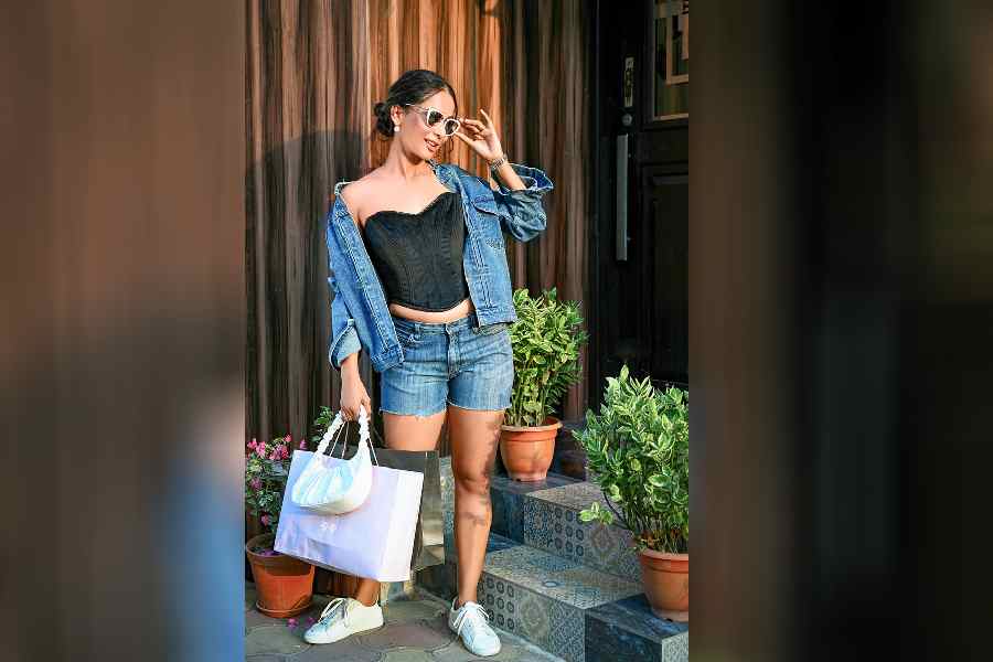 Corsets can be part of a casual everyday look and Ushoshi here replaces a boring spaghetti top with the black corset that amps up the fashion quotient. The combination of denim shorts and jacket was never this hot yet cool.