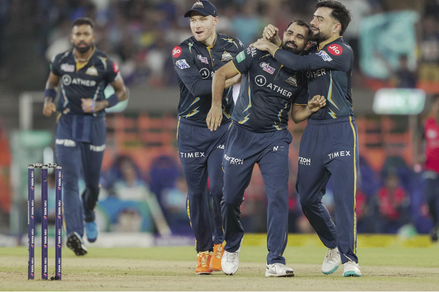 Gujarat Titans' Mohammed Shami along with teammates celebrates the wicket of Mumbai Indians batter Rohit Sharma during the IPL 2023 cricket playoff match between Gujarat Titans and Mumbai Indians at Narendra Modi Stadium in Ahmedabad on Friday.