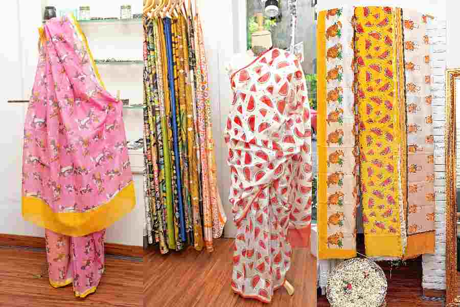 (l-r) A Tom and Jerry printed sari in pink with yellow border at Twine Tales, A sari with watermelon print, A glimpse of Printed Poppins on display