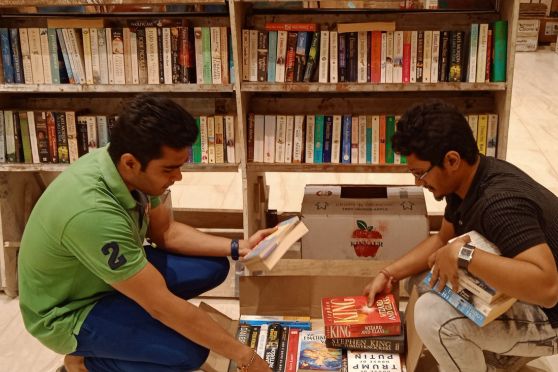 Booklovers from Kolkata deliberating on how to best fit the books into the box