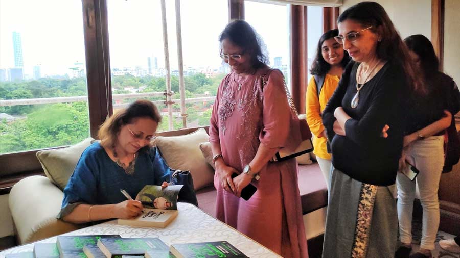 Krishan signing copies of her book, ‘Ghosts in the Dark Silence’