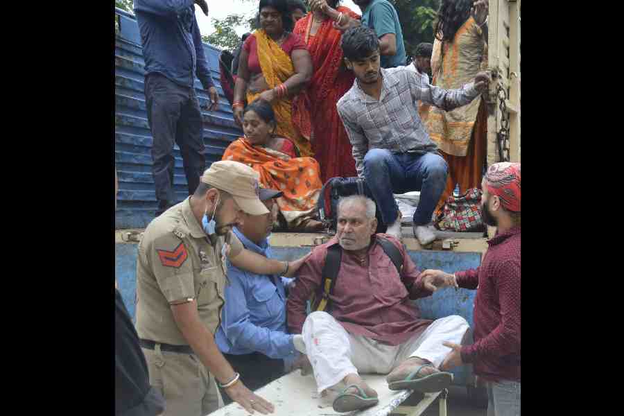 Security personnel rescuing injured passengers