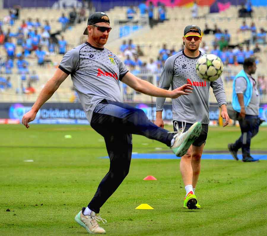 Power-hitter Heinrich Klaasen dribbles with a football to warm up before the match as fellow Protean David Miller looks on 
