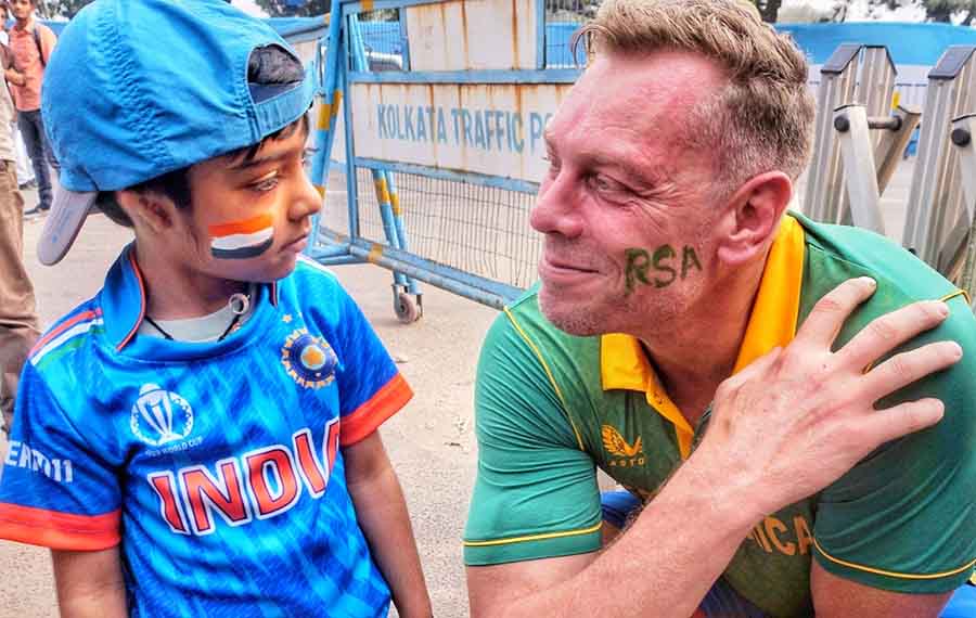 A little boy in blue with a South African supporter outside the Eden Gardens on Sunday
