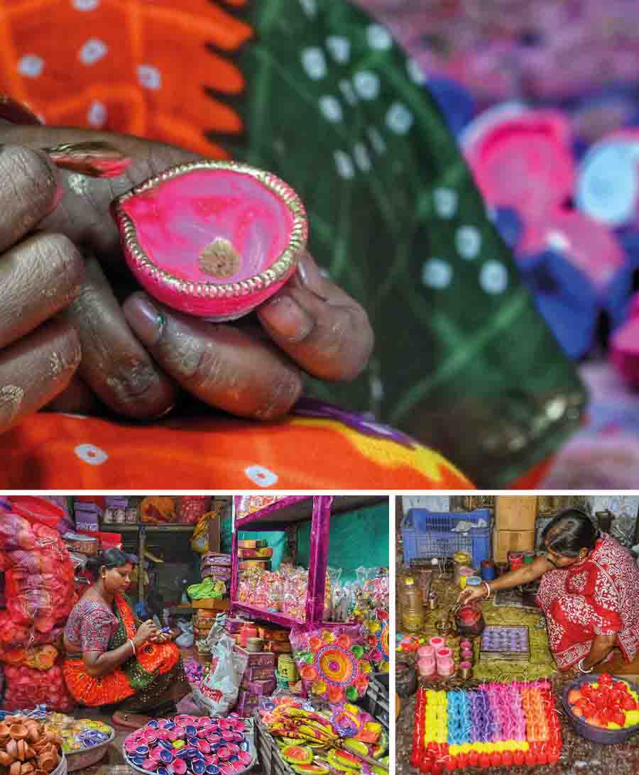 Women make diyas and candles for sale ahead of Diwali and Kali Puja 