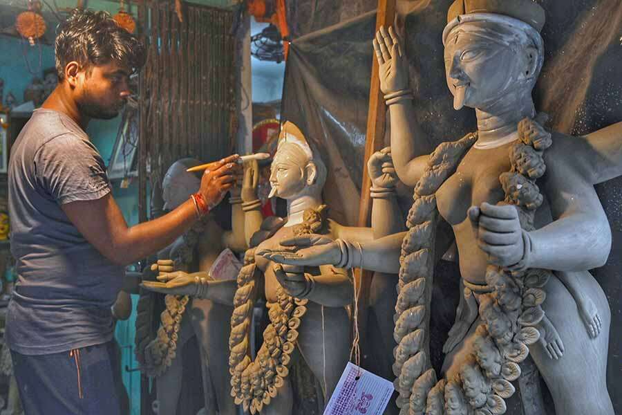 An artisan puts the finishing touches to an idol of goddess Kali in Kumartuli on Monday, ahead of Kali puja which will be celebrated on November 12 this year  