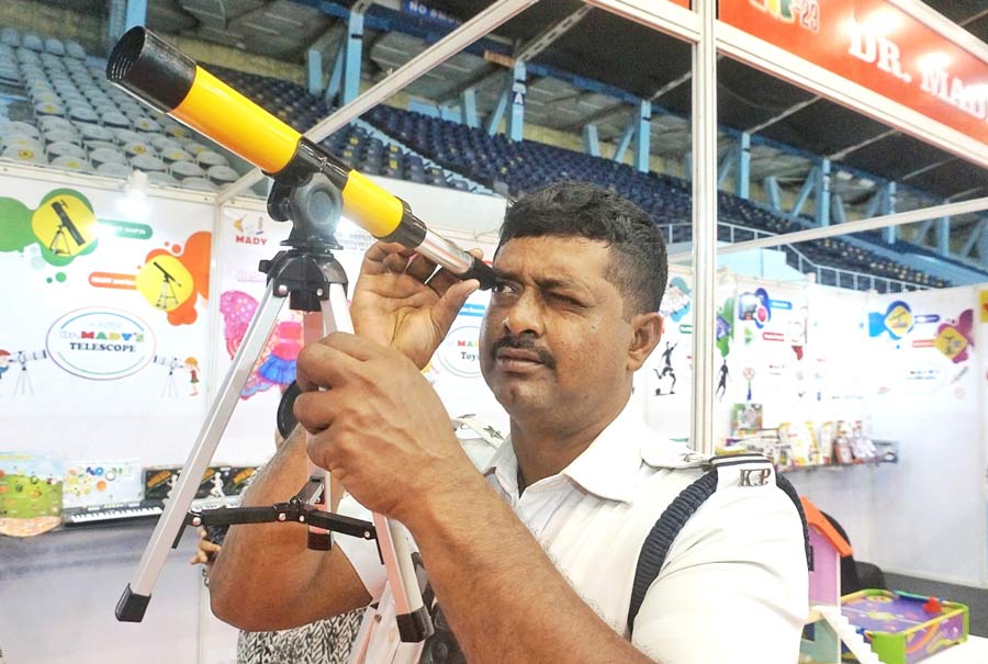 A personnel of the Kolkata police took a look at a telescope at Dr Mady’s stall