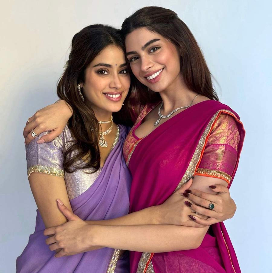 Actress Janhvi Kapoor embraced her sister Khushi Kapoor, who is set to make her acting debut with Zoya Akhtar’s upcoming Netflix film The Archies. Janhvi sported a violet sari coupled with a lavender printed blouse, while Khushi went for a deep pink sari. 