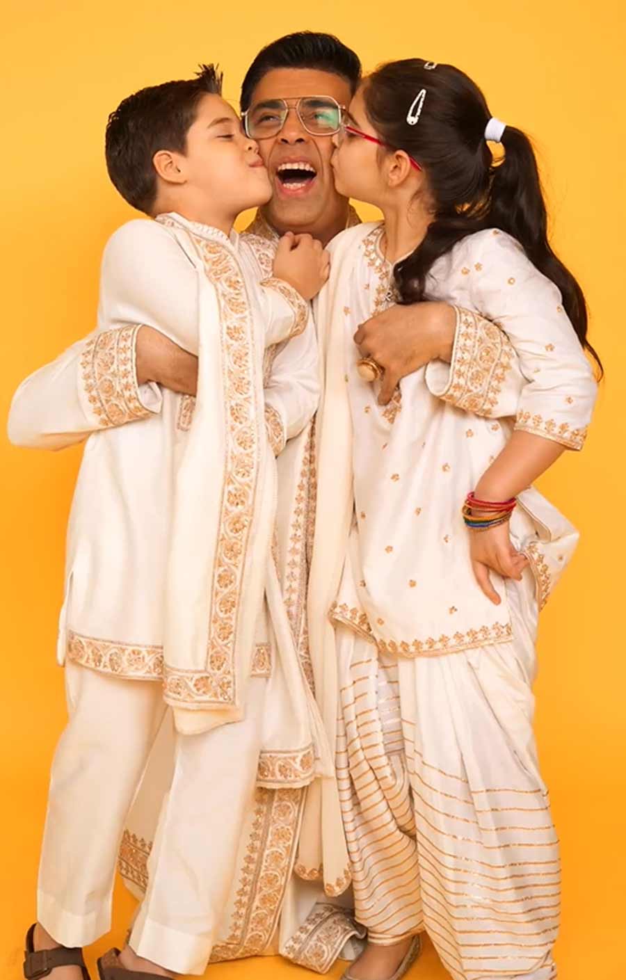 Filmmaker Karan Johar twinned in white with his twins Yash and Roohi. 