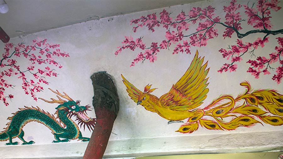 Chinese-styled frescos adorn the ceilings and their side panels of the Chinese Kali Temple roof