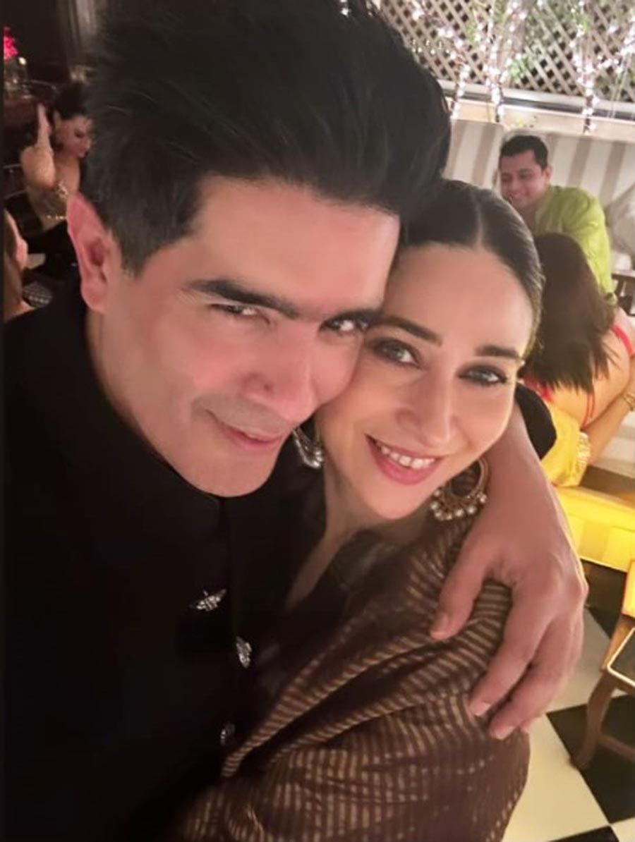 Manish Malhotra hugged Karisma Kapoor as they posed for a selfie. 