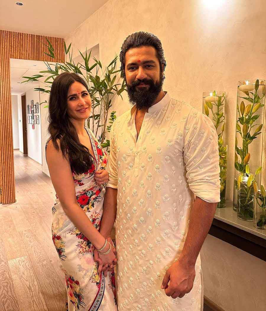 Tiger 3 actress Katrina Kaif looked radiant in a white floral print sari alongside husband Vicky Kaushal who nailed the white embroidered kurta look. 