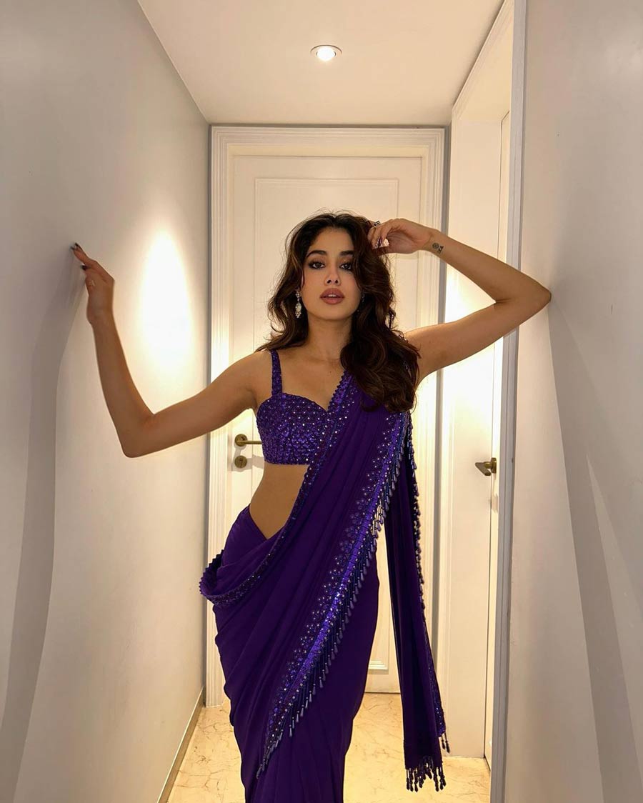 Janhvi Kapoor sported a purple mirror and sequin hand-embroidered sari with a matching strappy blouse, and did her own makeup. 