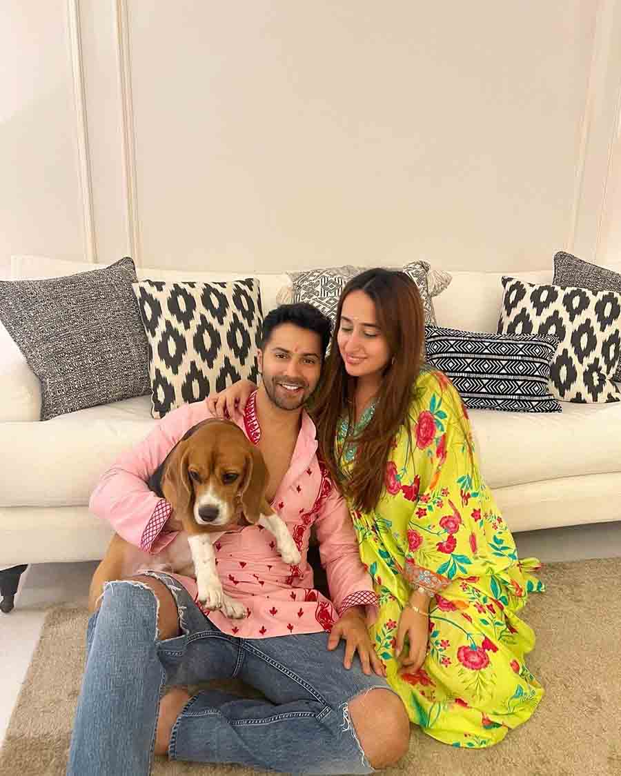 Varun Dhawan shared a family picture with his wife Natasha Dalal and their beagle dog. The Bhediya actor wore a light-pink kurta with red embroidery, while Natasha sported a floral-printed greenish yellow outfit.