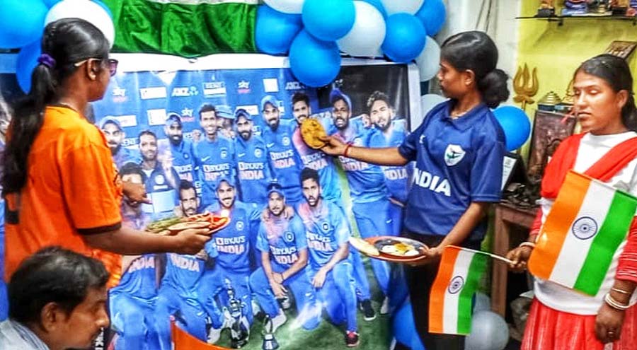 Visually challenged young women at Songbedan apply ‘bhai phonta’ on the photographs of Team India players praying for their success in the ICC Men’s Cricket World Cup 