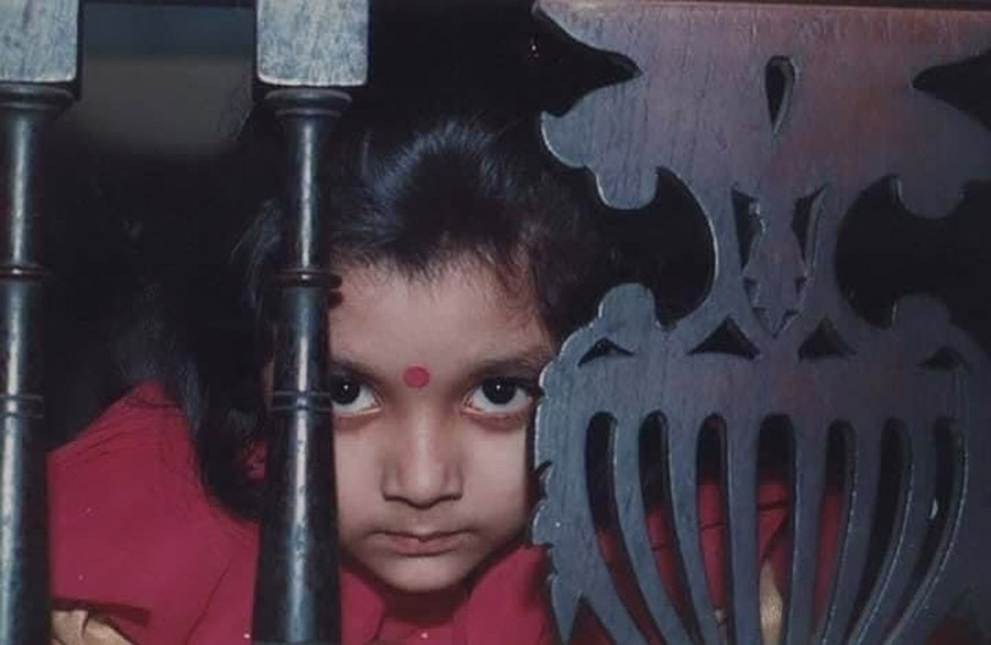 Actress Devlina Kumar uploaded this childhood photograph of herself captioning: ‘Hiii  Thinking what dushtumi to do next  #happychildrensday #inmyhead #stillthisage’