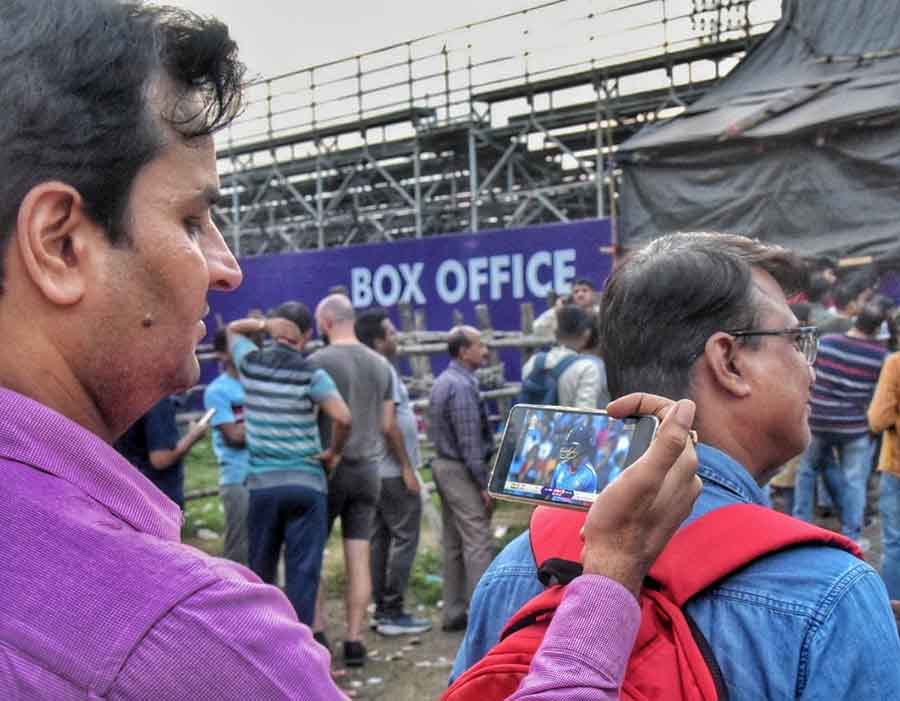 Cricket fans queue up for tickets for Thursday's South Africa vs Australia semi-final match at the Eden Gardens. One fan was spotted watching the semi-final face-off between India and New Zealand on the phone as he waited to reach the counter 