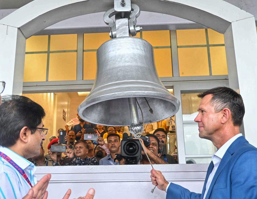 Australian cricket coach and former batsman Ricky Ponting rings the bell at the Eden Gardens to mark the start of the second semi-final as Cricket Association of Bengal president Snehasish Ganguly looks on
