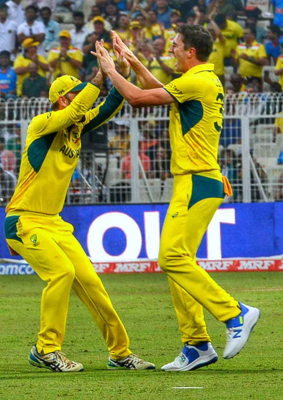 Glenn Maxwell and Pat Cummins celebrate an Aussie wicket 