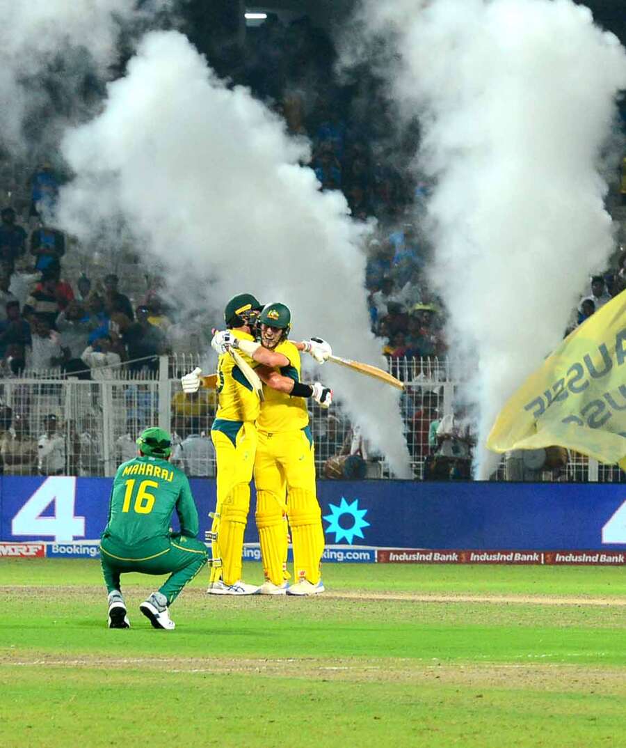 Australian skipper Pat Cummins and Mitchell Starc embrace each other to celebrate the win that takes them to the final of the ICC World Cup 2023 as Keshav Maharaj sits dejected, reflecting the mood in the South African camp