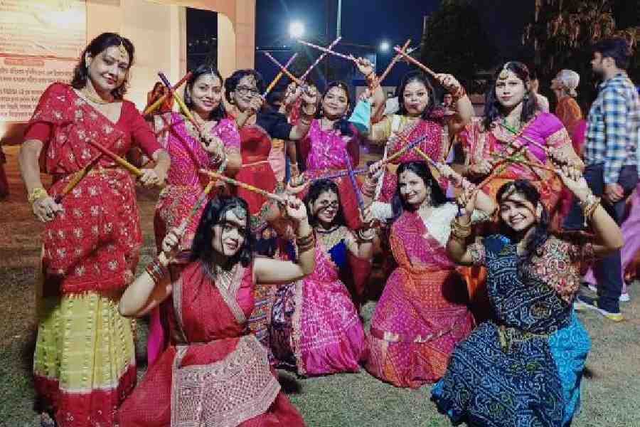 Women of New Town’s AE Block pose with their dandiya sticks