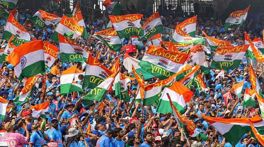Fans in blue wave the Tricolour in support of Team India