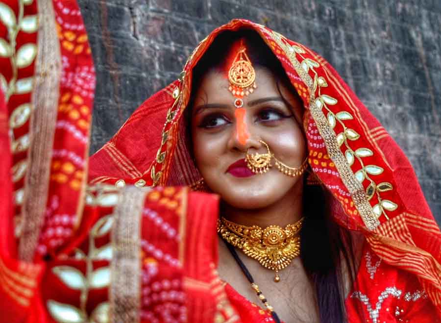 The radiant smile on a woman’s face portrays the immense satisfaction at the end of the four-day arduous puja