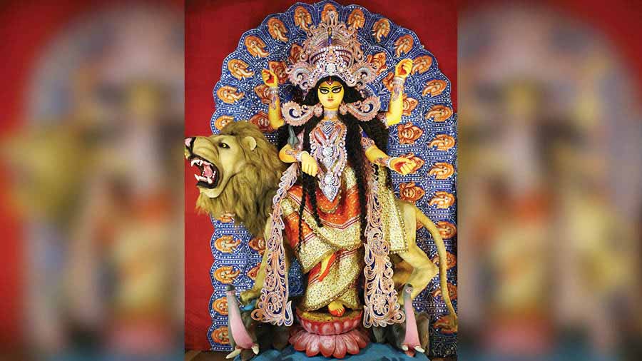 The goddess, apart from holding various weapons in her four hands, also holds a snake around her