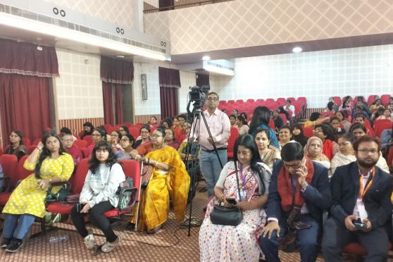 The audience listened intently to the speakers.