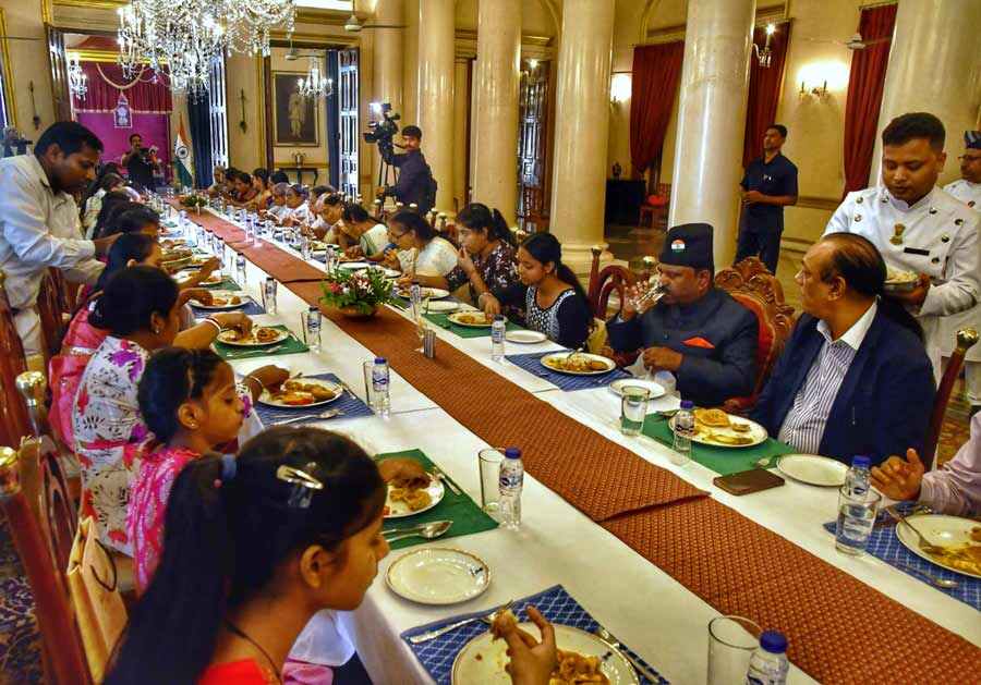 Senior citizens and children relish lunch at Raj Bhavan on the first anniversary of CV Ananda Bose as governor on Thursday  