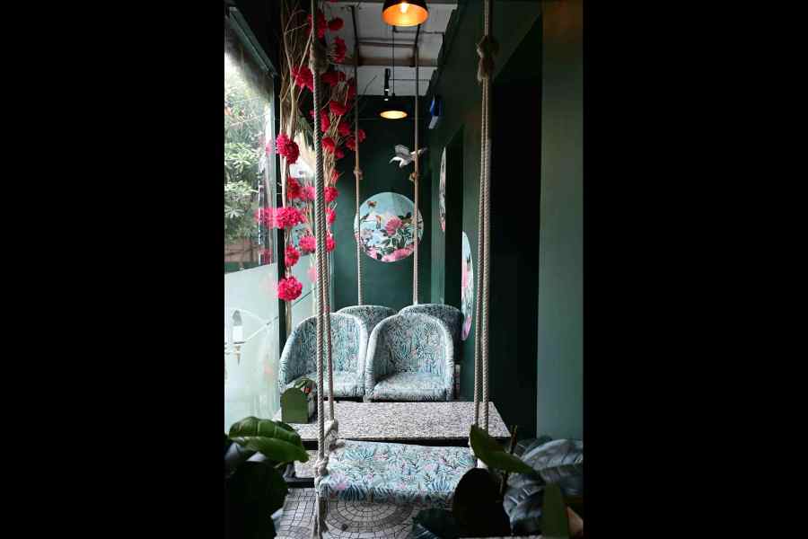A swing in the middle of the “jungle” with floral-printed plush seats add to the vibe of the place